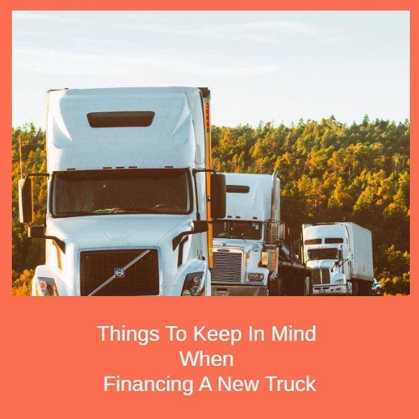 White trucks on road with trees in background. Things To Keep In Mind When Financing A New Truck